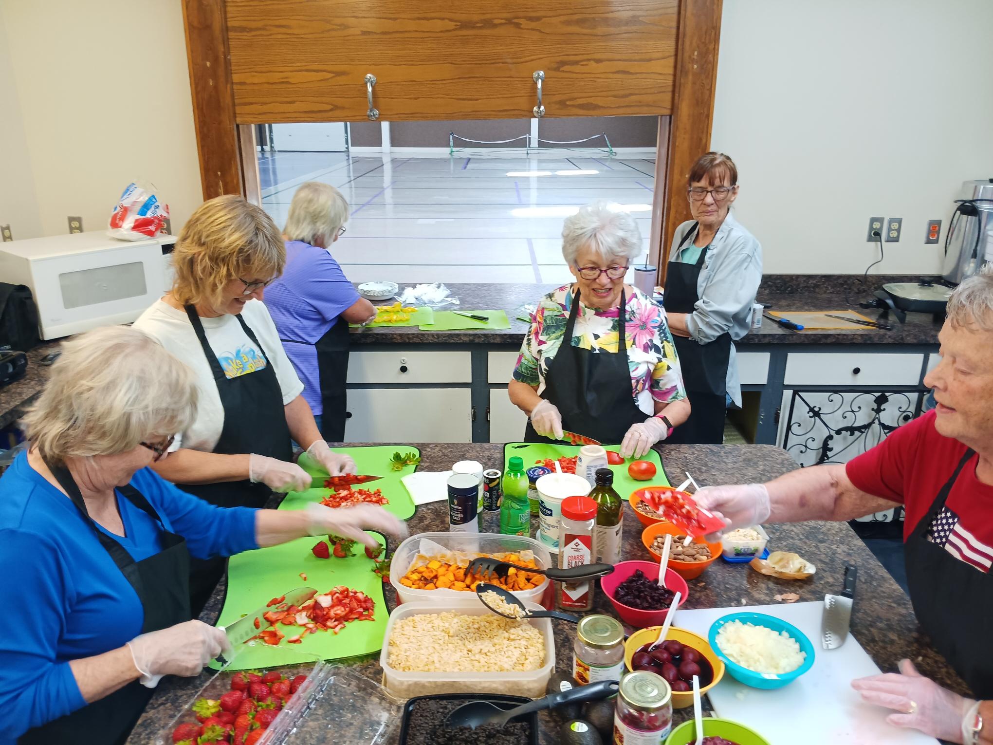 Participants create colorful Mediterranean grain bowls, learning healthy cooking techniques in FCS cooking class.